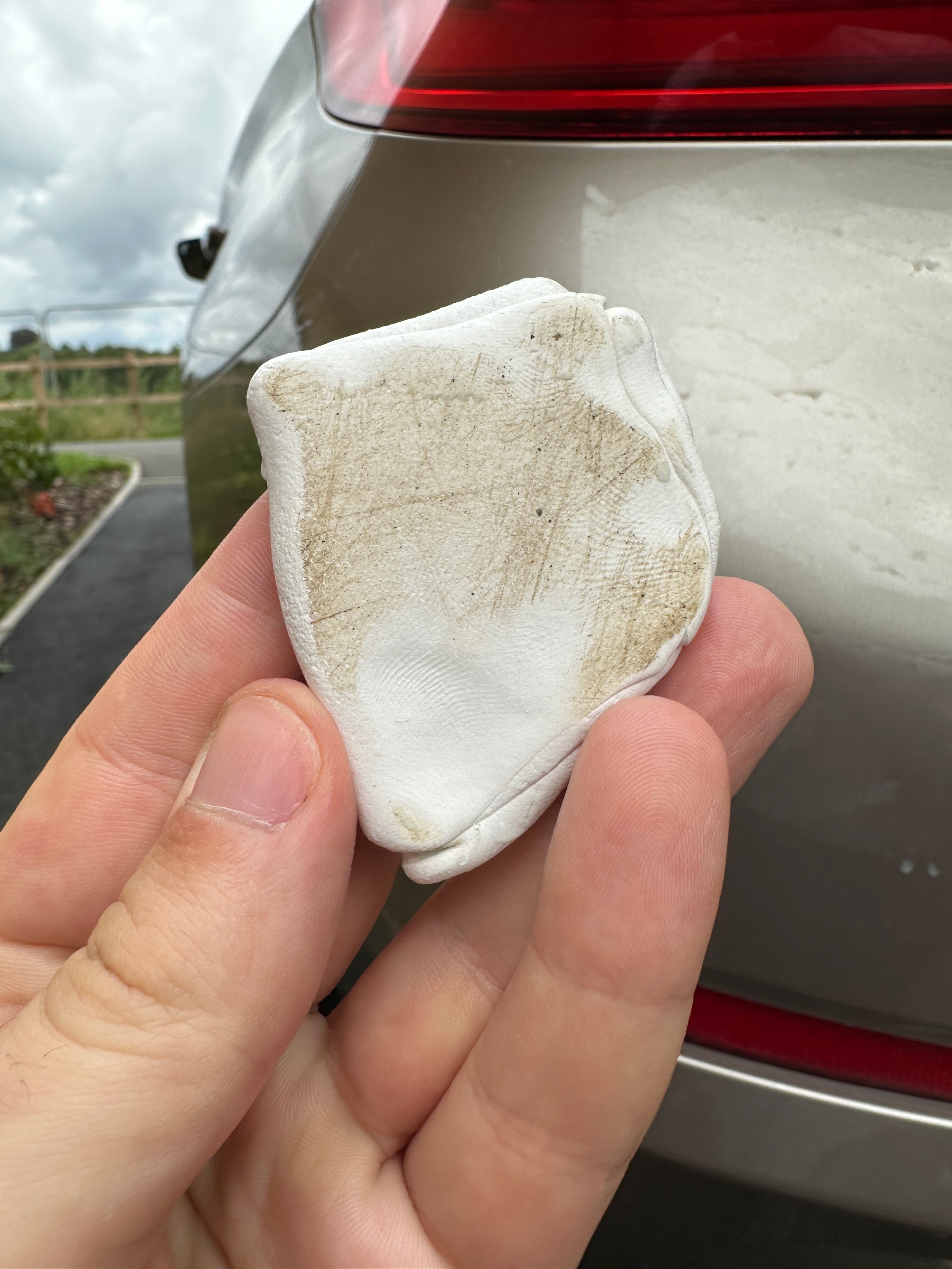 Clay bar showing contamination removed from car paintwork